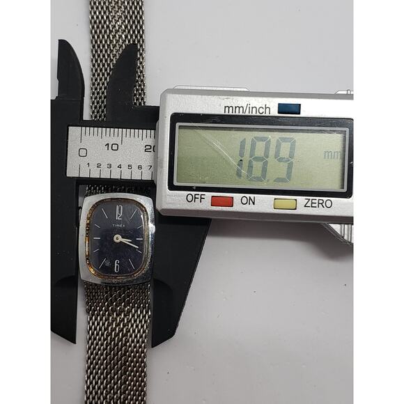 Women\'s Timex dress watch. Black square face with silver bevel. Decorative band